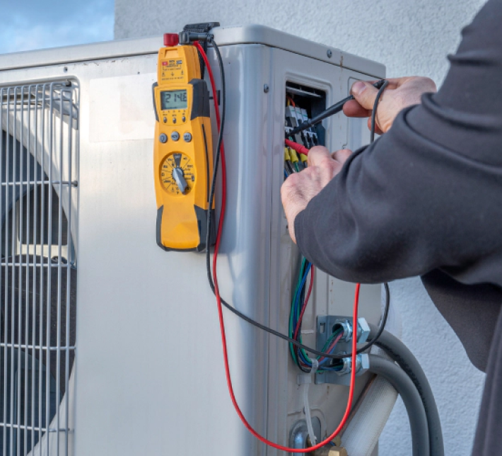 One of our technicians repairing the wiring of an AC Unit