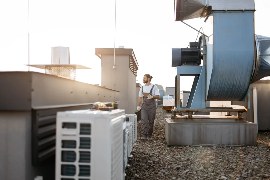 HVAC Tech Repairing Rooftop HVAC Unit